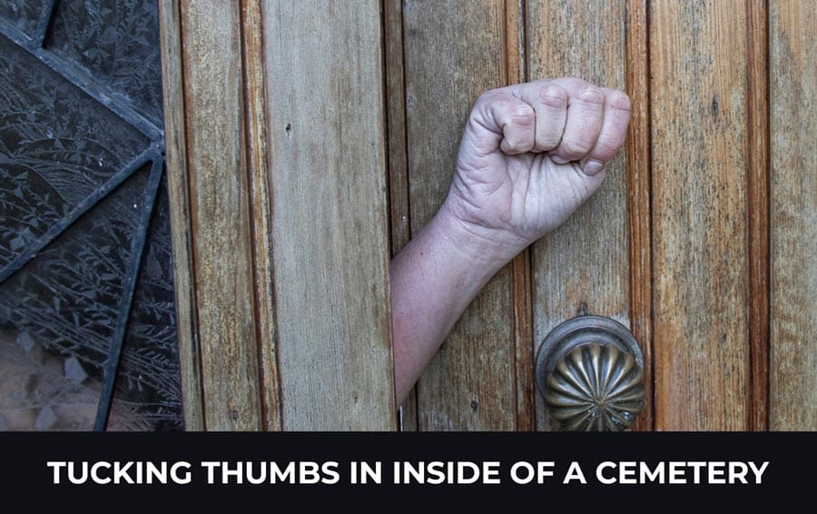 Tucking thumbs in inside of a cemetery